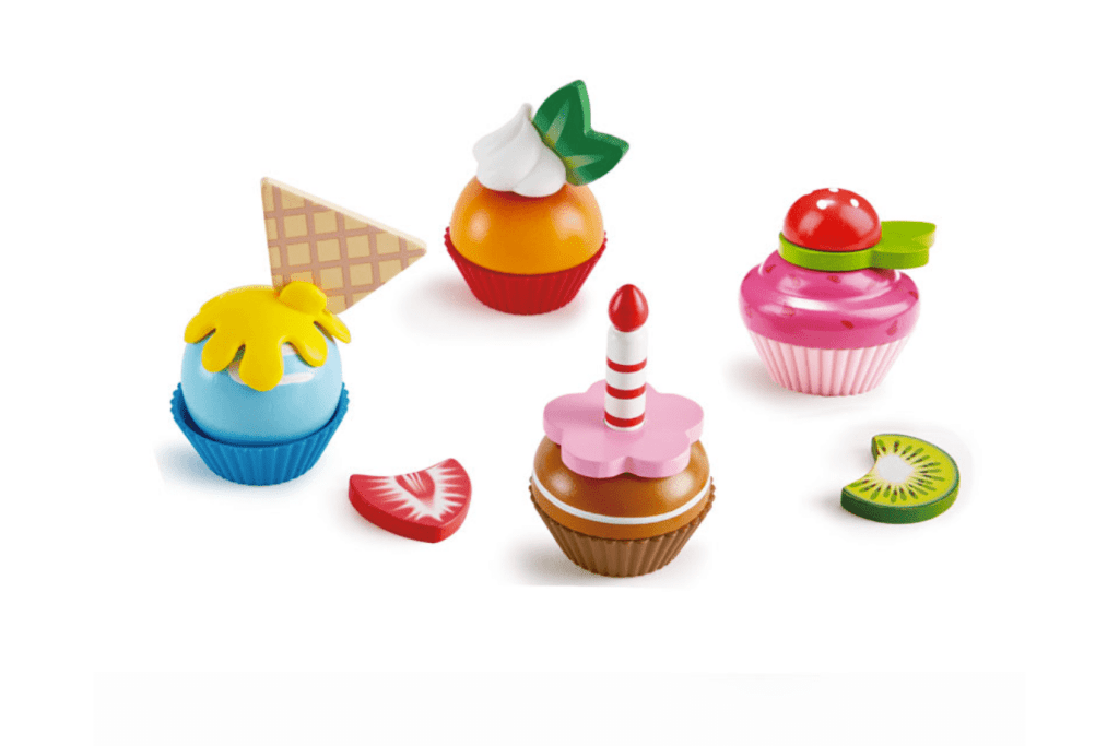 Hape's Make Your Own Cupcakes, pretend playset, Includes 18 wooden pieces:  Four cups, Four servings of cake, 10 toppings and garnishes, including a candle, fruits and a wafer, 3 years and up, toys for dramatic play, toys for imagination and creativity, wooden toys for kids, The Montessori Room, Toronto, Ontario, Canada.