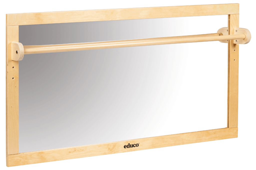 Infant Toddler Mirror with Wooden Bar by Educo, AMI approved, classroom quality mirror, mirror for Montessori Nido, mirror for Montessori infant classroom, mirror for Montessori toddler classroom, pull up bar for children learning how to walk, walking aids, refinement of movement, unbreakable mirror, adjustable height, horizontal mirror, vertical mirror, The Montessori Room, Toronto, Ontario.