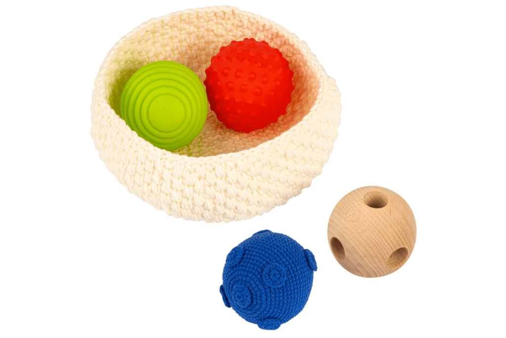Basket with Balls, The Montessori Room, Toronto, Ontario, Montessori materials for infants, toys that encourage crawling, toys that encourage movement, toys for sensorial exploration, balls for infants.The Play Kits by Lovevery, Lovevery, Montessori toy subscription, buy Lovevery item individually, Lovevery Canada, Lovevery in store, The Inspector Play kit, Months 7-8